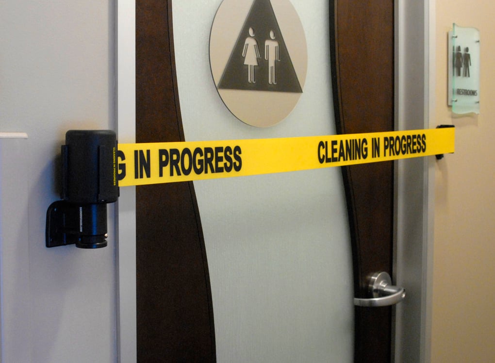 image of safety barrier blocking door to bathroom that is being cleaned